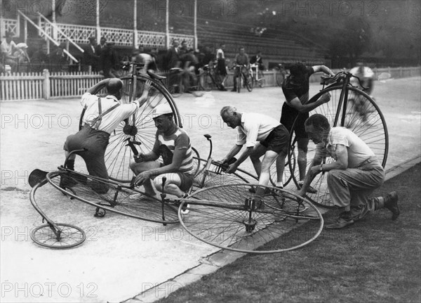 Men working on penny-farthings at a velodrome, c1900-1939(?). Artist: Unknown