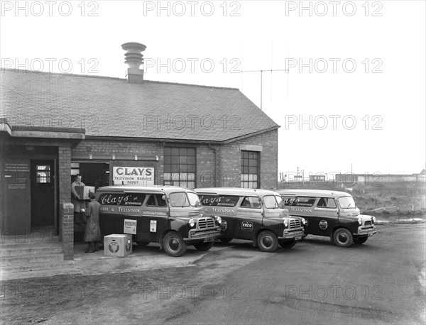 Austin vans being loaded outside Clays TV repair depot, Mexborough, South Yorkshire, 1959. Artist: Michael Walters