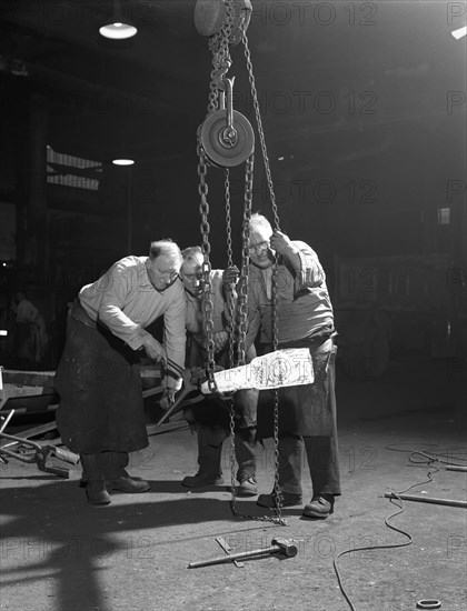 Three workers from Edgar Allen's handle a red hot billet, Sheffield, South Yorkshire, 1963. Artist: Michael Walters