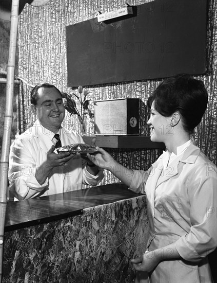 Serving a meal to a customer in a cafe, Mexborough, South Yorkshire, 1964. Artist: Michael Walters