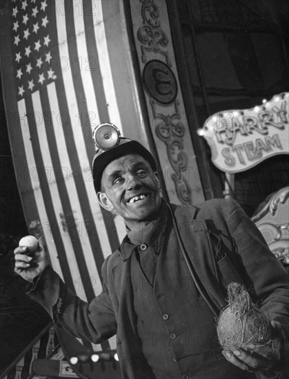 Miner at a fairground, Conisbrough, near Doncaster, South Yorkshire, 1955. Artist: Michael Walters