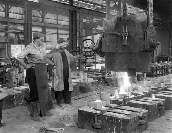 Pouring a small casting at Edgar Allen's Steel foundry, Sheffield, South Yorkshire, 1963. Artist: Michael Walters