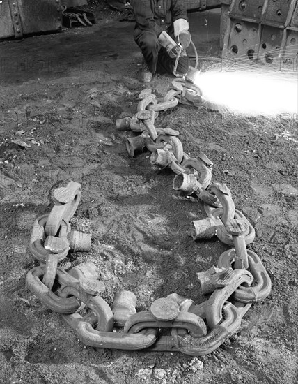 Cutting off lead from a manganese chain casting, Sheffield, South Yorkshire, 1965. Artist: Michael Walters