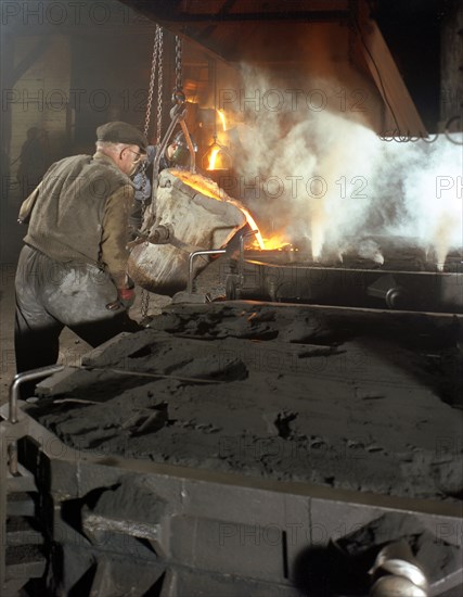 Pouring molten metal from a cupola into moulds, steel bath production, Hull, Humberside, 1965. Artist: Michael Walters