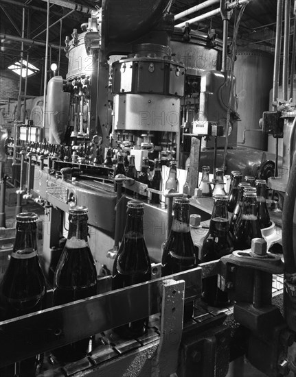Beer bottles being filled at Ward & Sons, Swinton, South Yorkshire, 1960. Artist: Michael Walters
