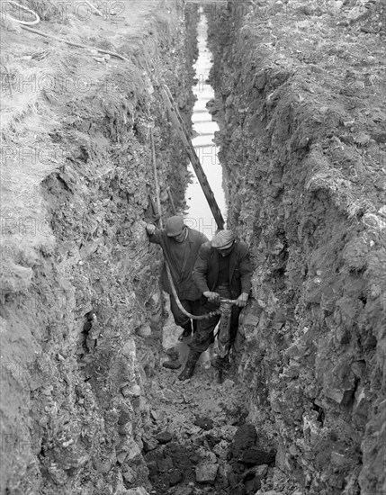 Civil engineers in a trench with a pneumatic drill, Oldcoats, Nottinghamshire, 1961. Artist: Michael Walters