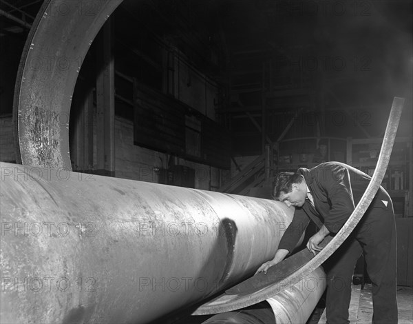 Checking the curve of a steel plate, Edgar Allen's steel foundry, Sheffield, Yorkshire, 1964. Artist: Michael Walters