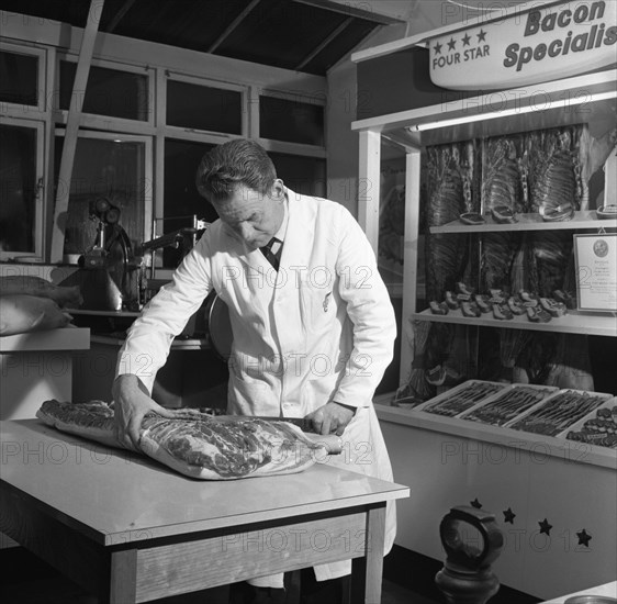 Butcher from Danish Bacon giving a demonstration, Kilnhurst, South Yorkshire, 1961. Artist: Michael Walters