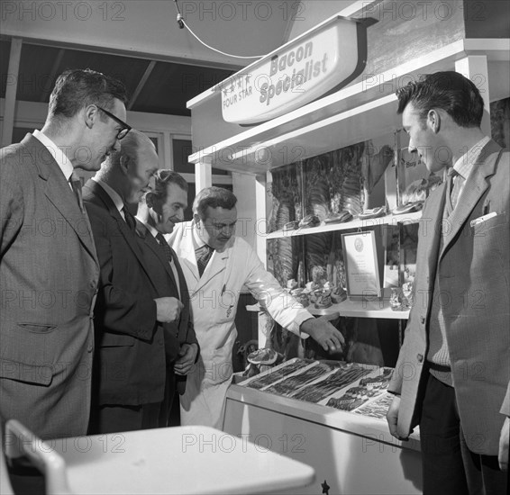 Butcher from Danish Bacon giving a demonstration, Kilnhurst, South Yorkshire, 1961.  Artist: Michael Walters