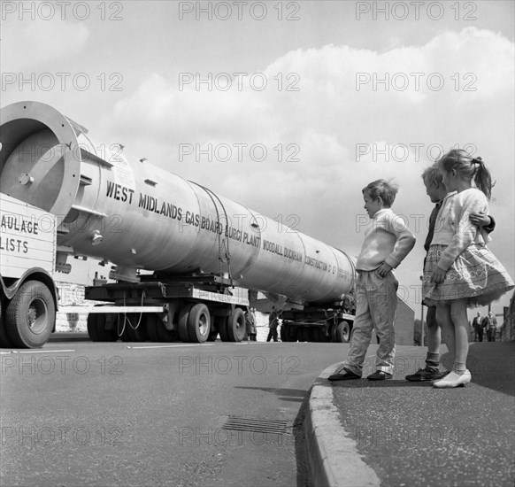 An absorption tower being transported by road, Dukenfield, Manchester, 1962. Artist: Michael Walters