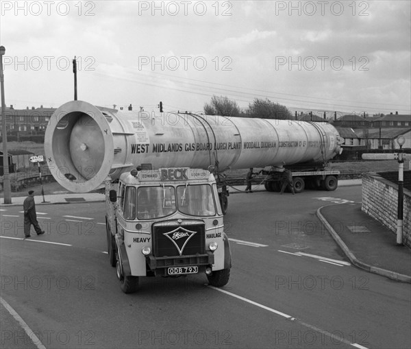 An absorption tower being transported by road, Dukenfield, Manchester, 1962. Artist: Michael Walters