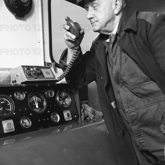 Train driver on an intercom, South Yorkshire, 1964. Artist: Michael Walters