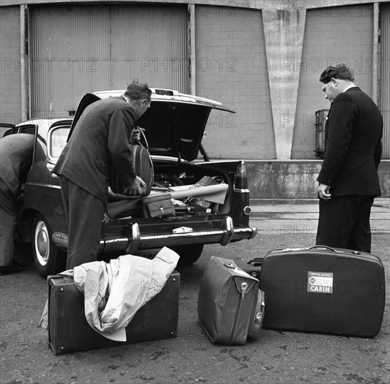 A 1961 Austin Westminster being loaded with luggage on Amsterdam docks, Netherlands 1963. Artist: Michael Walters
