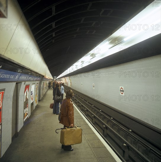 Passengers waiting at Blackhorse tube station on the Victoria Line, London, 1974.  Artist: Michael Walters