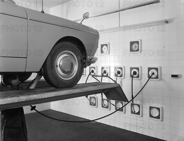 A traditional lubrication bay and mechanic at a garage, Sheffield, South Yorkshire, 1965. Artist: Michael Walters