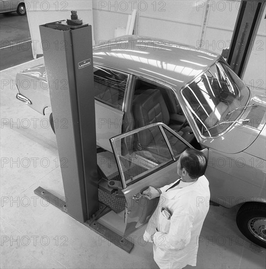 Ford Zodiac on an assymetric lift, Sheffield, South Yorkshire, 1972. Artist: Michael Walters