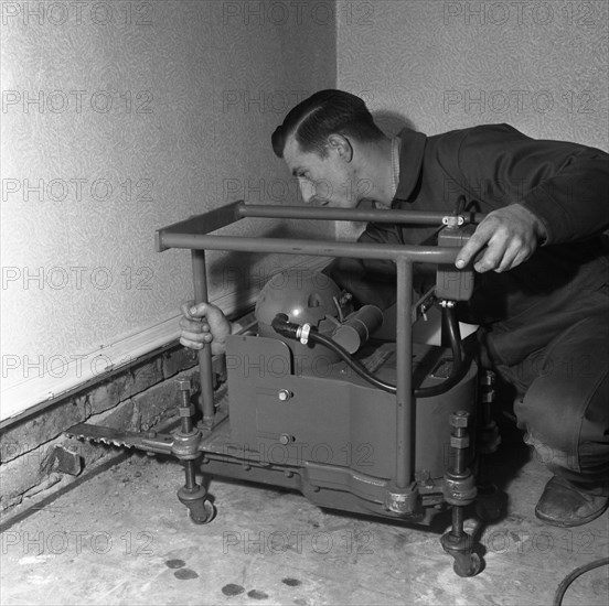 Installing a damp proof course in a house in Goldthorpe, South Yorkshire, 1957.  Artist: Michael Walters