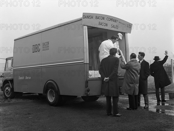 Traders buying bacon direct from a Danish Bacon wholesale van, Kilnhurst, South Yorkshire, 1961. Artist: Michael Walters