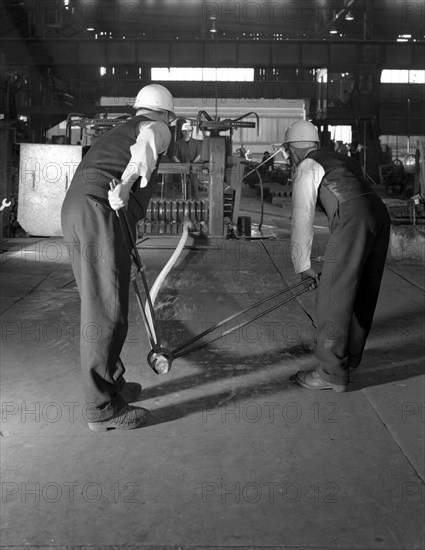 Rolling steel bars, Park Gate Iron & Steel Co, Rotherham, South Yorkshire, 1964. Artist: Michael Walters