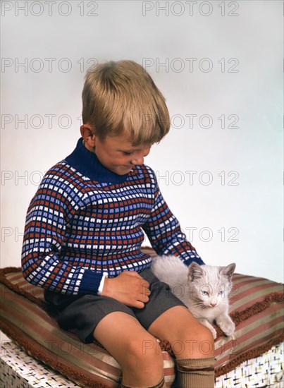 Child with a cat, 1963. Artist: Michael Walters