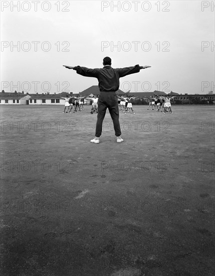 Games master taking a gym class, Airedale school, Castleford, West Yorkshire, 1962. Artist: Michael Walters