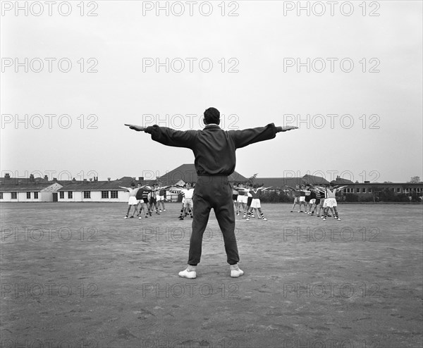 Games master taking a gym class, Airedale school, Castleford, West Yorkshire, 1962. Artist: Michael Walters