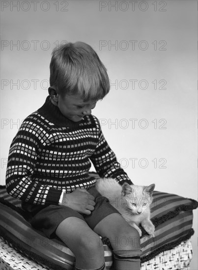 Child with a cat, 1963. Artist: Michael Walters