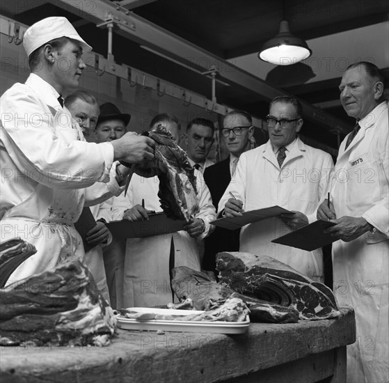 Apprentice butcher showing his work to competition judges, Barnsley, South Yorkshire, 1963. Artist: Michael Walters