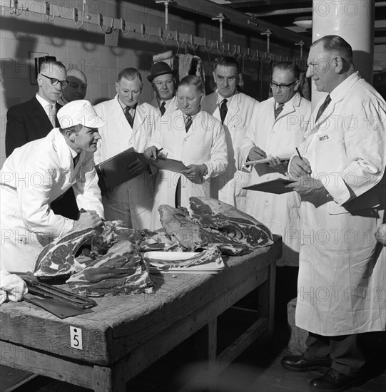 Apprentice butcher showing his work to competition judges, Barnsley, South Yorkshire, 1963. Artist: Michael Walters