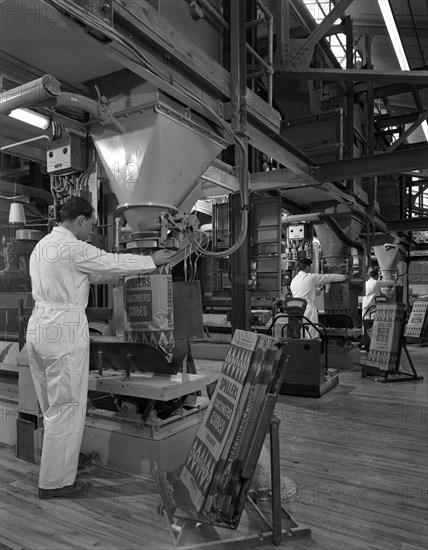 Filling bags of animal feed, Spillers Animal foods, Gainsborough, Lincolnshire, 1963. Artist: Michael Walters