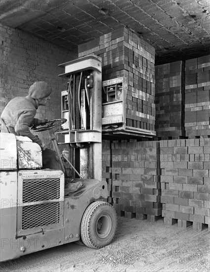 A yardsman stacking pallets of bricks, Whitwick Brickworks, Coalville, Leicestershire, 1963. Artist: Michael Walters