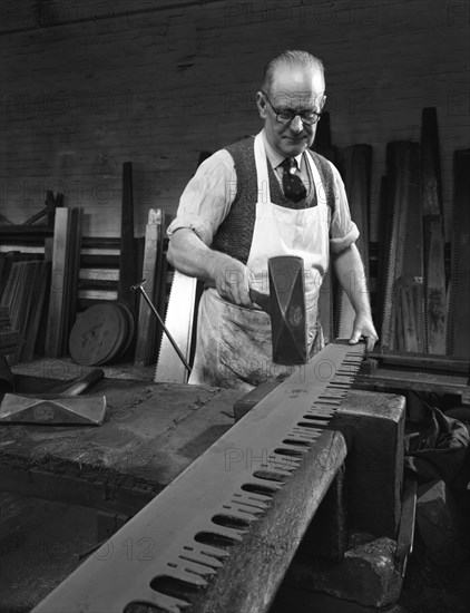 Tensioning the crosscut on a two metre saw blade, Sheffield, South Yorkshire, 1963. Artist: Michael Walters