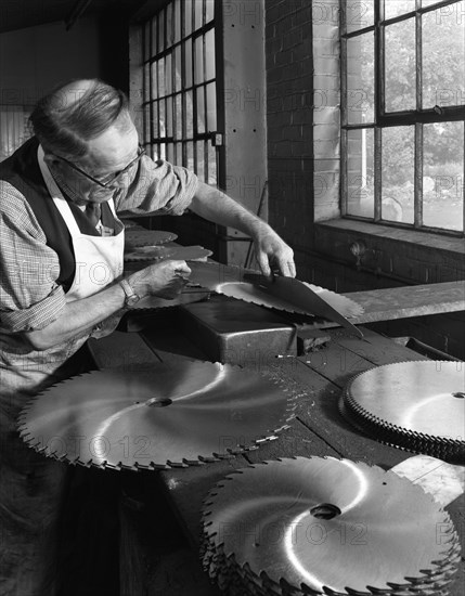 Tensioning circular saws at Slack Sellers & Co Ltd, Sheffield, 1963. Artist: Michael Walters