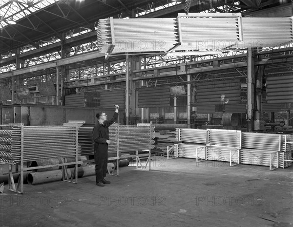 Lowering galvanised heat exchangers, Edgar Allen Steel Co, Sheffield, South Yorkshire, 1964. Artist: Michael Walters