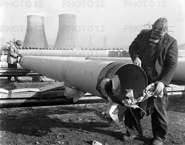 Pipe wrapping to prevent corrosion on steel pipes, Old Denaby, South Yorkshire, 1961. Artist: Michael Walters