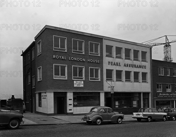 Morris Minor and a Triumph Herald outside the Royal Insurance Building, Rotherham, S Yorks, 1962. Artist: Michael Walters