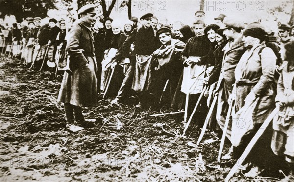 Townsfolk wait to scour the fields for potatoes left by farmers, Germany, World War I, c1914-c1918. Artist: Unknown