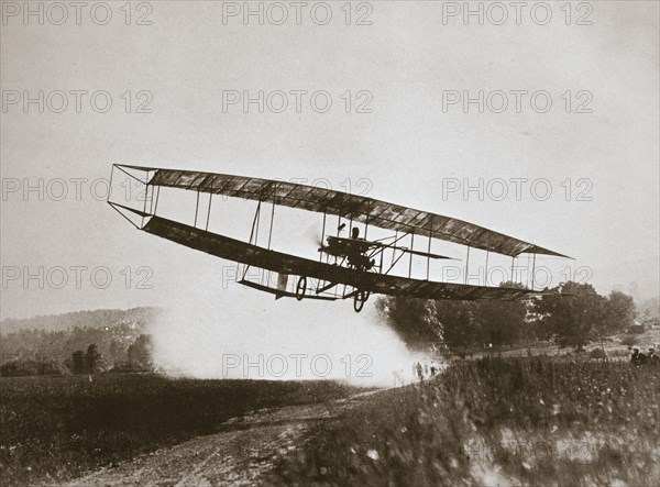 American aviator Glenn Curtiss making the first heavier-than-air flight in his 'June Bug', 1908. Artist: Edwin Levick