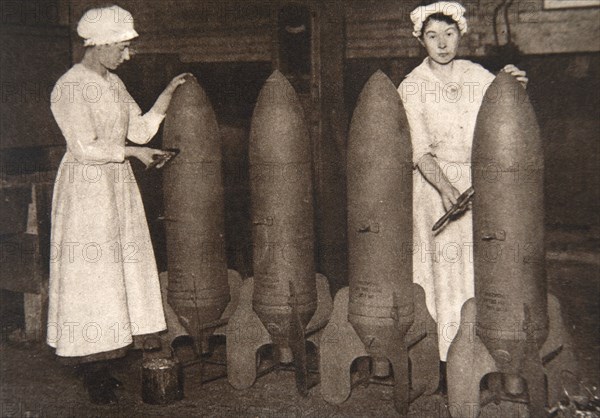 Women munitions workers putting a coat of paint on aerial bombs, World War I, c1914-c1918. Artist: S and G