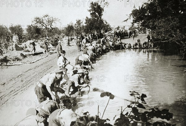 Transport men cleaning their harness at a pond after wet weather, France, World War I, 1916. Artist: Unknown