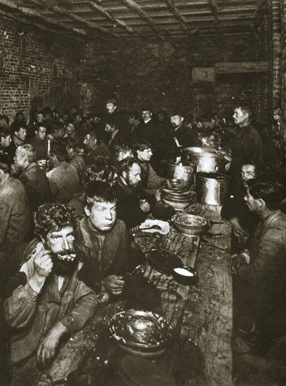 Russian manual labourers eating a meal, late 19th century. Artist: Unknown