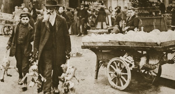 Old Jewish man and his grandson carrying some fowls, Wentworth Street, Stepney, 20th century. Artist: Unknown