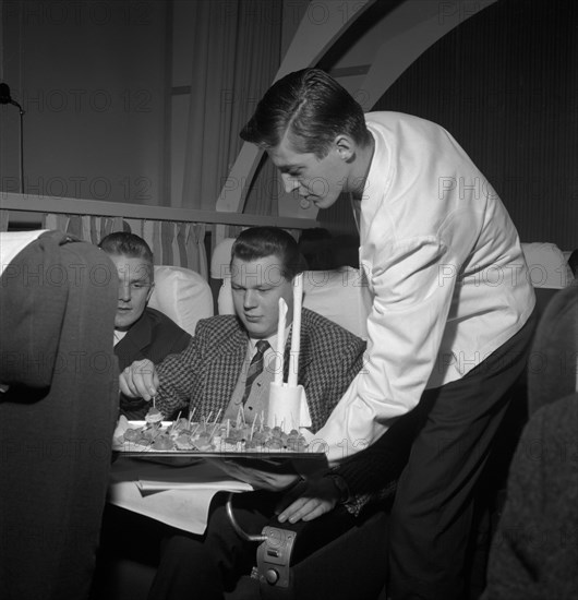 SAS steward serving snacks on a flight, 1960. Artist: Torkel Lindeberg