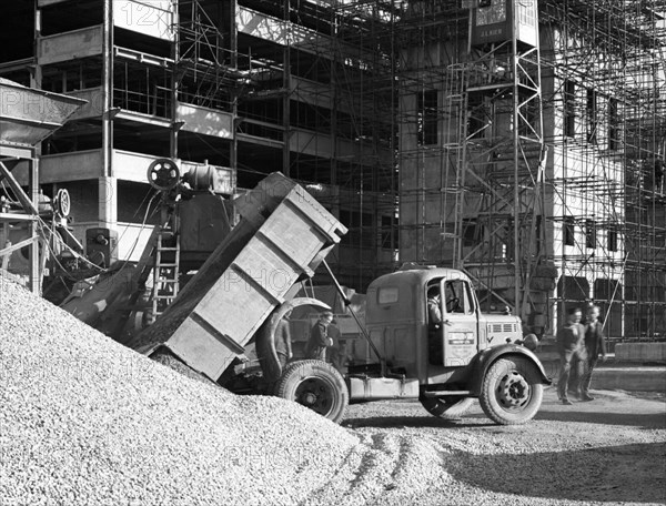 Early 1950s Bedford M Tipper delivering aggregates to a building site, South Yorkshire, July 1954. Artist: Michael Walters