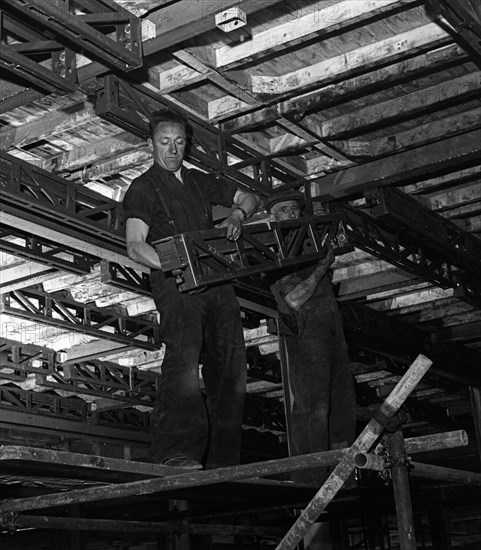 Engineers lifting steelwork into position, South Yorkshire, 1954. Artist: Michael Walters