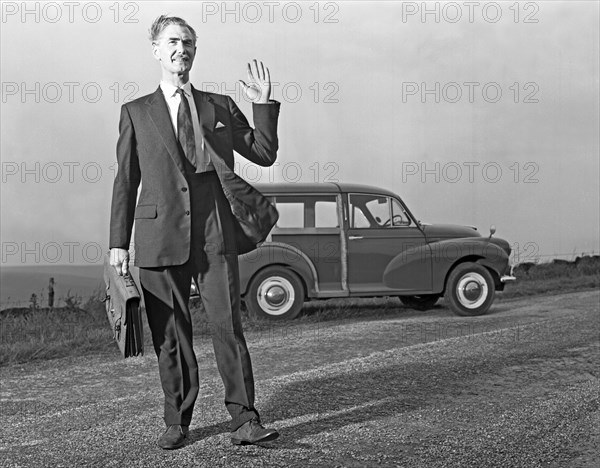 Waving Sales rep with a Moris Minor Shooting Brake, 3rd Aug 1963. Artist: Michael Walters