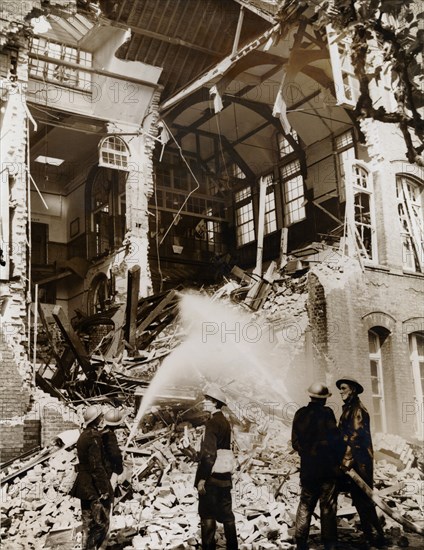 Firemen at work on a children's school, East London, the Blitz, World War II, 13 September 1940. Artist: Unknown