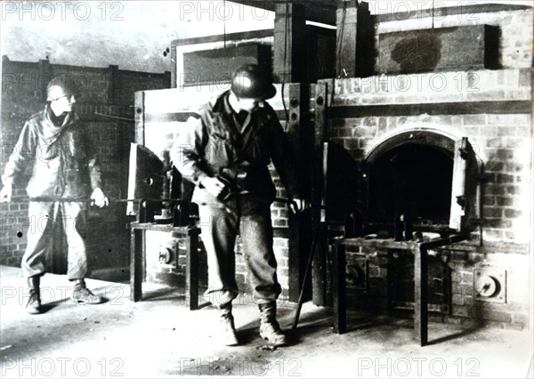 American soldiers studying a crematorium, Dachau concentration camp, Bavaria, Germany, c1945. Artist: Unknown