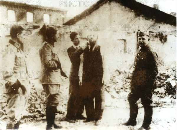 A barber watched by German troops, World War II, c1939-c1945. Artist: Unknown