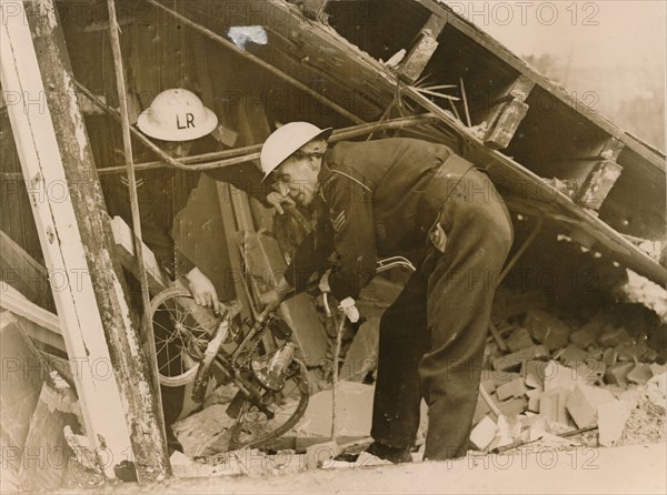 Rescue workers reteieving a bicycle from a wrecked Warden's Post, London. Artist: Unknown